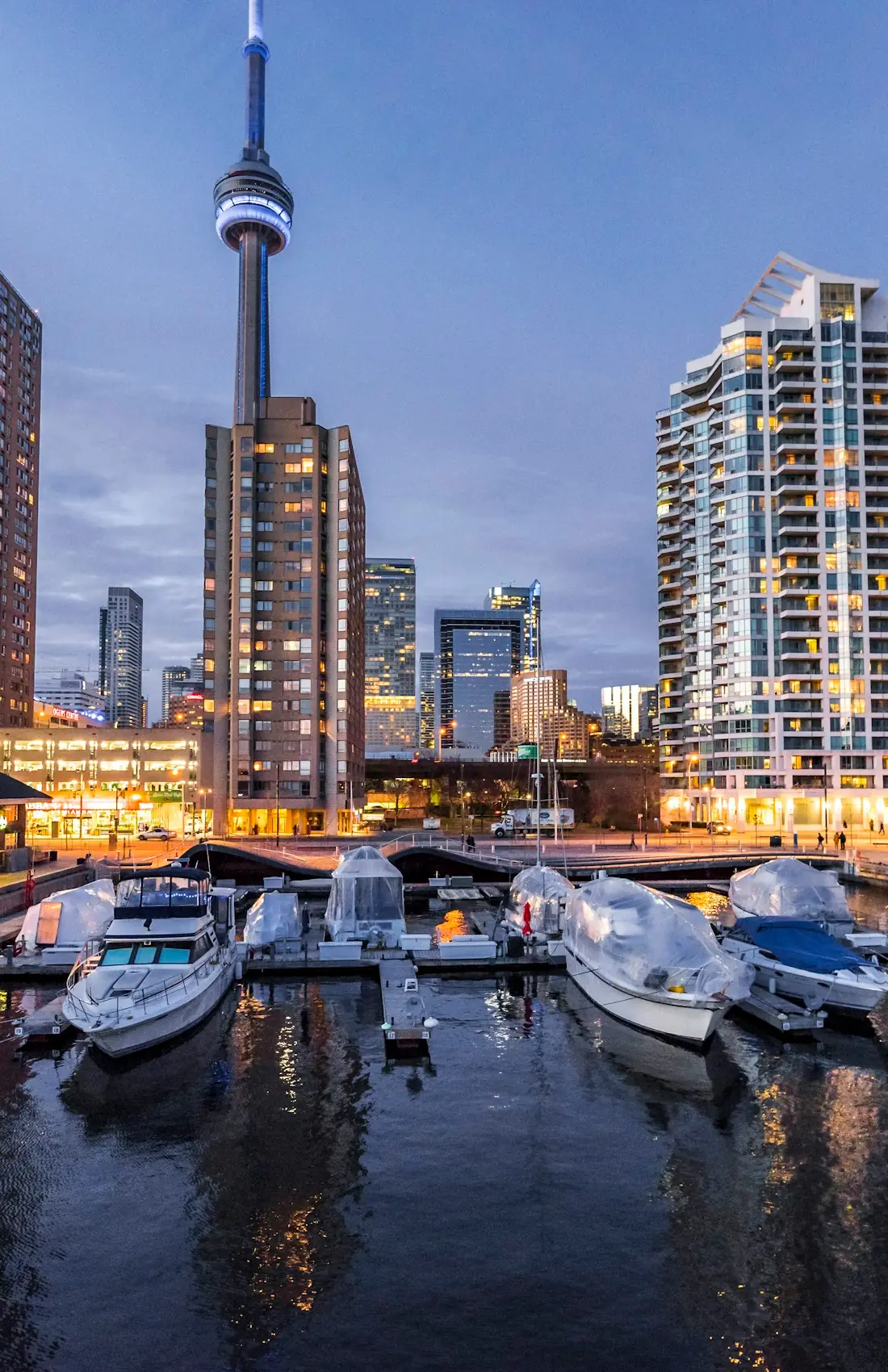 The Toronto skyline at blue hour, seen across the harbourfront marina, Ontario, Canada